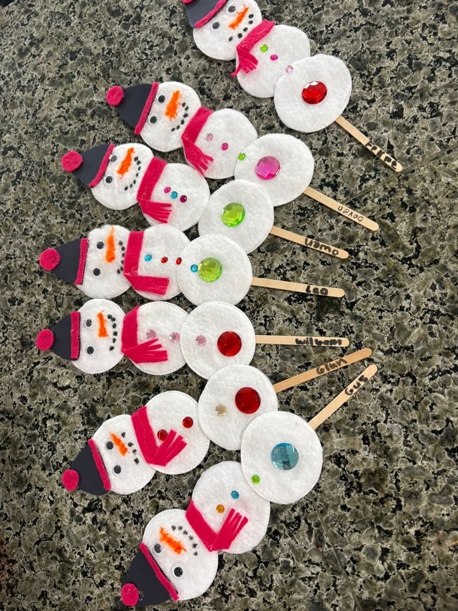 A row of cotton-pad snowmen craft display